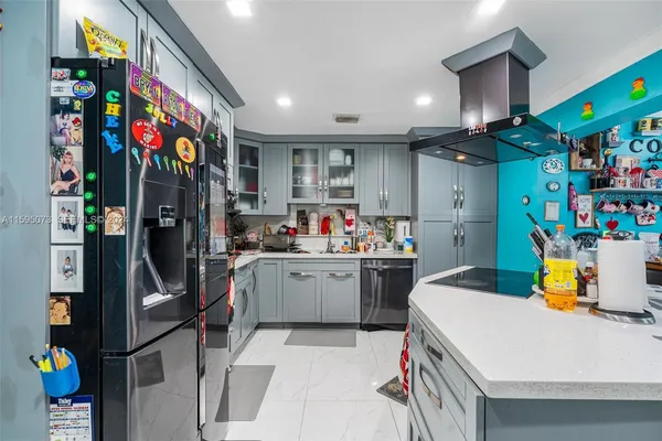 a kitchen view with lot of counter top space and refrigerator