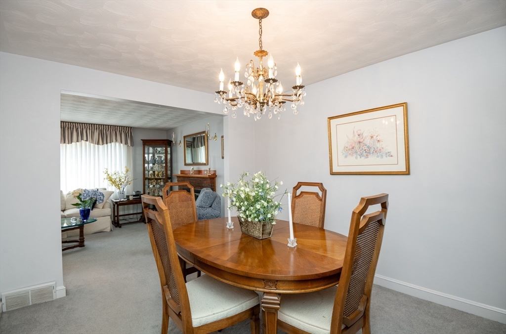 6 Janice Lane Stoneham, MA 02180 - Photo 11 of 35 a view of a dining room with furniture and chandelier