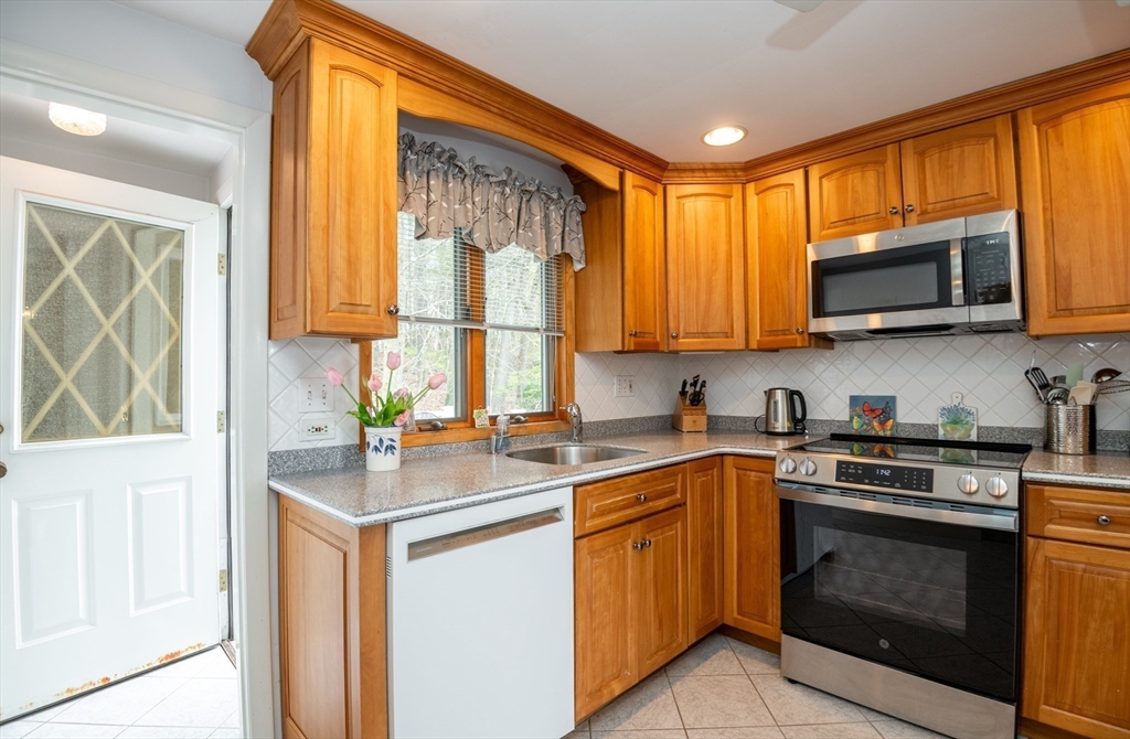 6 Janice Lane Stoneham, MA 02180 - Photo 14 of 35 a kitchen with a sink stove top oven and microwave