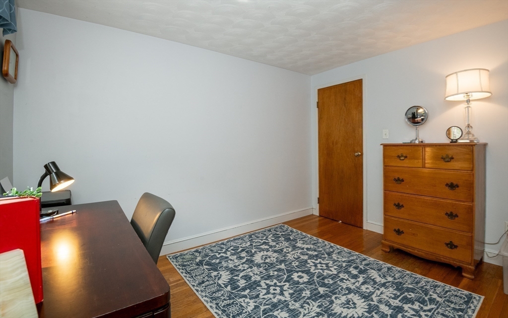 6 Janice Lane Stoneham, MA 02180 - Photo 21 of 35 a view of a workspace with furniture and wooden floor