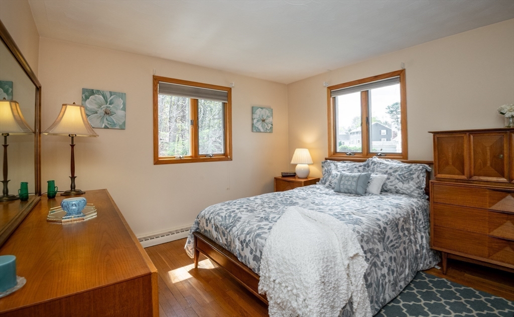 6 Janice Lane Stoneham, MA 02180 - Photo 22 of 35 a bedroom with a bed and a dresser with wooden floor