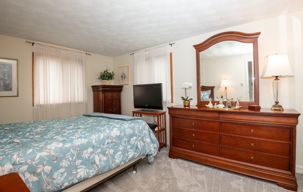 6 Janice Lane Stoneham, MA 02180 - Photo 24 of 35 a bedroom with a bed and a flat screen tv