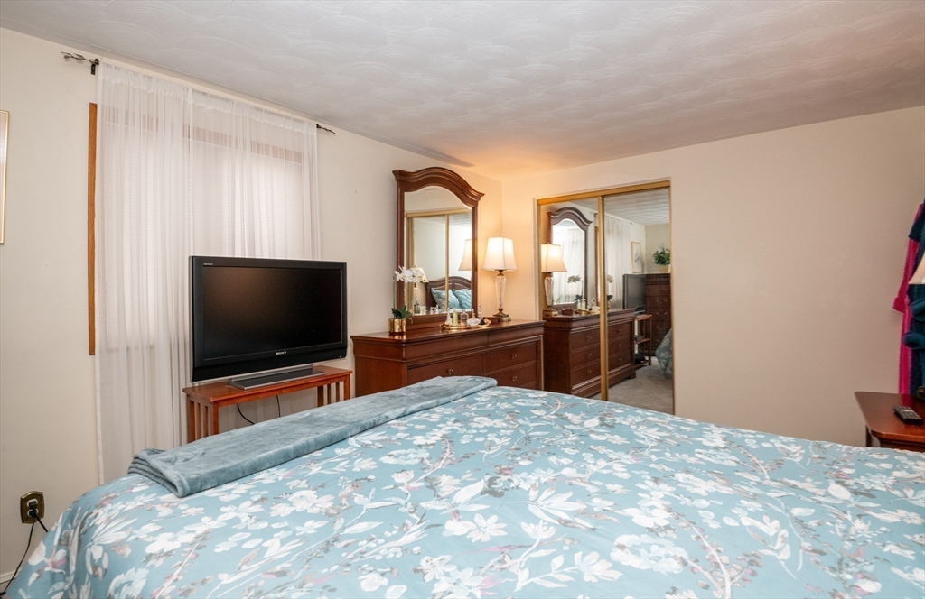 6 Janice Lane Stoneham, MA 02180 - Photo 25 of 35 a bedroom with a bed and a flat screen tv