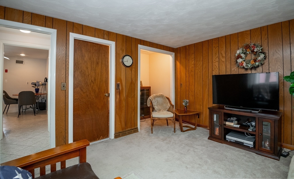 6 Janice Lane Stoneham, MA 02180 - Photo 27 of 35 a living room with furniture and a flat screen tv