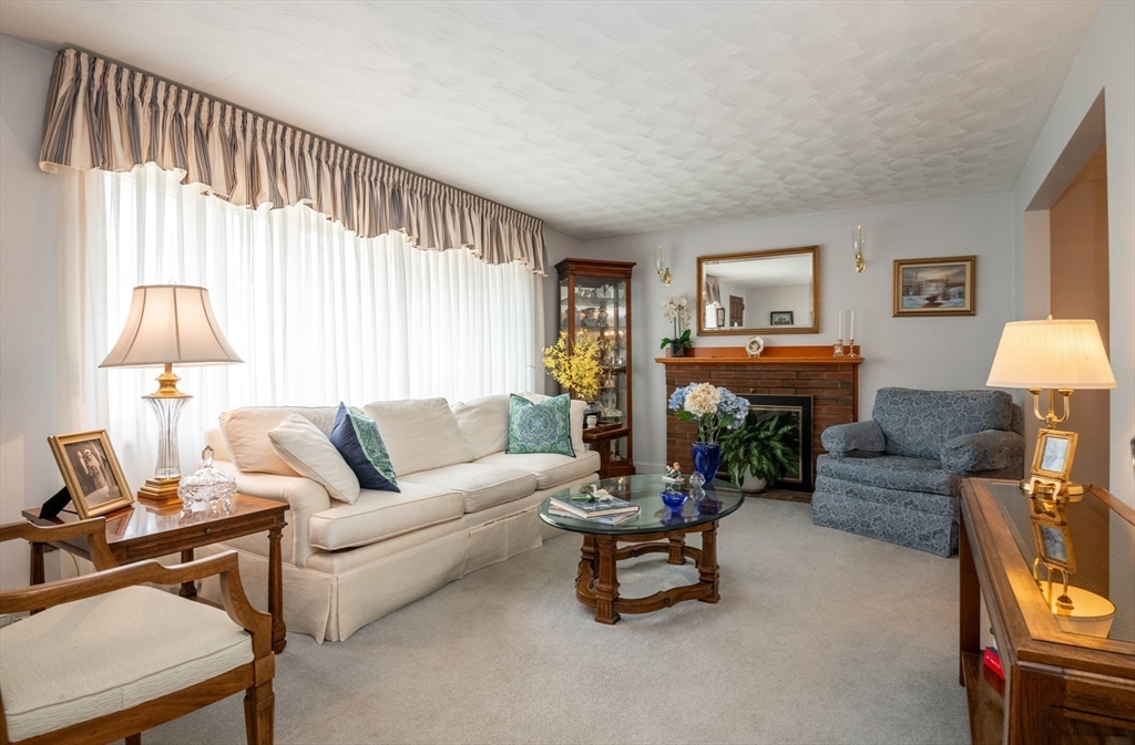 6 Janice Lane Stoneham, MA 02180 - Photo 8 of 35 a living room with furniture a window and a flat screen tv