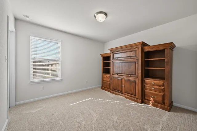 a view of an empty room with a closet