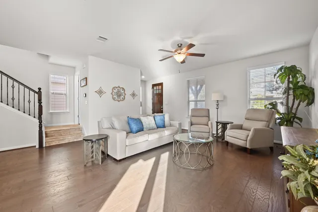 a living room with furniture and wooden floor
