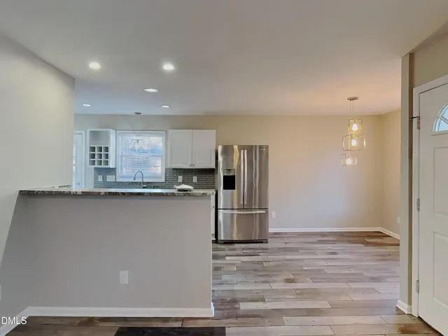 a kitchen with stainless steel appliances a refrigerator and a stove top oven
