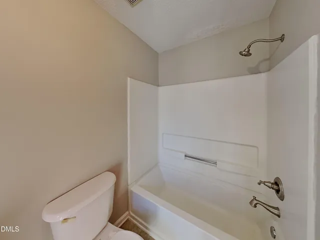 a bathroom with a toilet and a bathtub