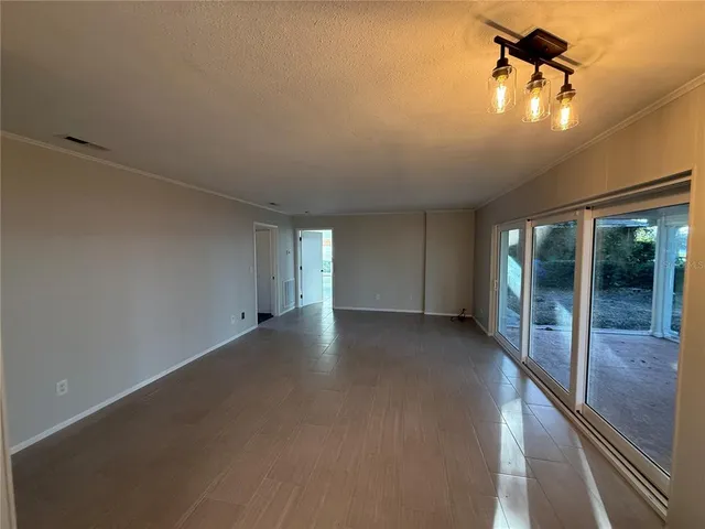 a view of a livingroom with a ceiling fan and window
