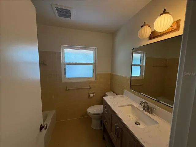 a view of an empty room with a fireplace