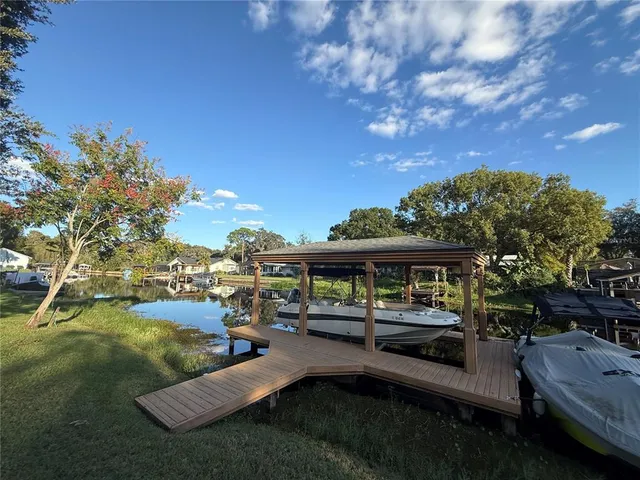 a swimming pool view with a seating space and a garden view