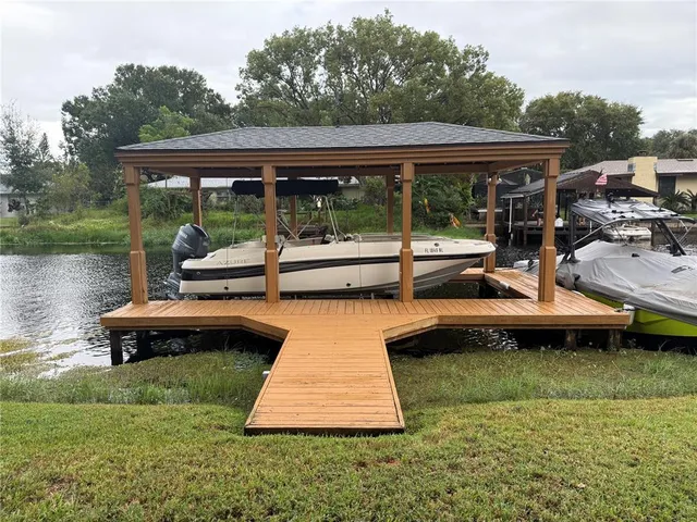 a backyard of a house with yard table and chairs