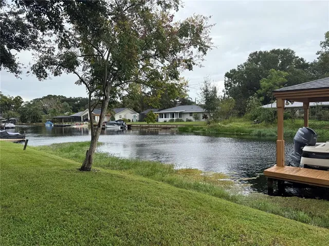 a swimming pool with outdoor seating and garden