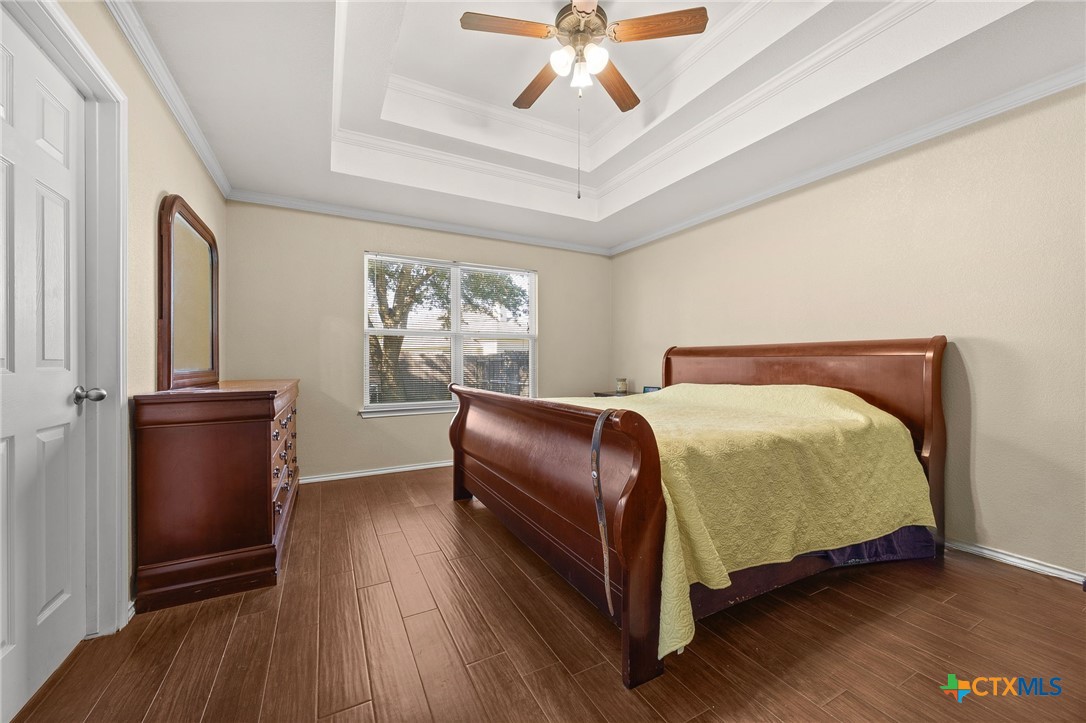 910 Neuberry Cliffe Temple, TX 76502 - Photo 14 of 32 a bedroom with a bed and wooden floor