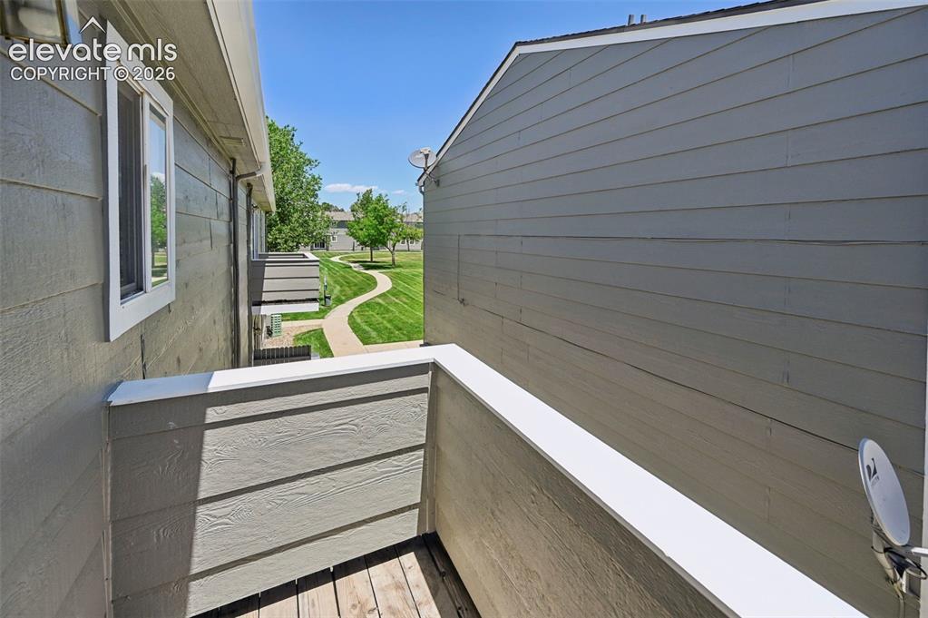 431 Kitfield View Colorado Springs, CO 80916 - Photo 27 of 27 a view of a balcony with wooden floor and fence