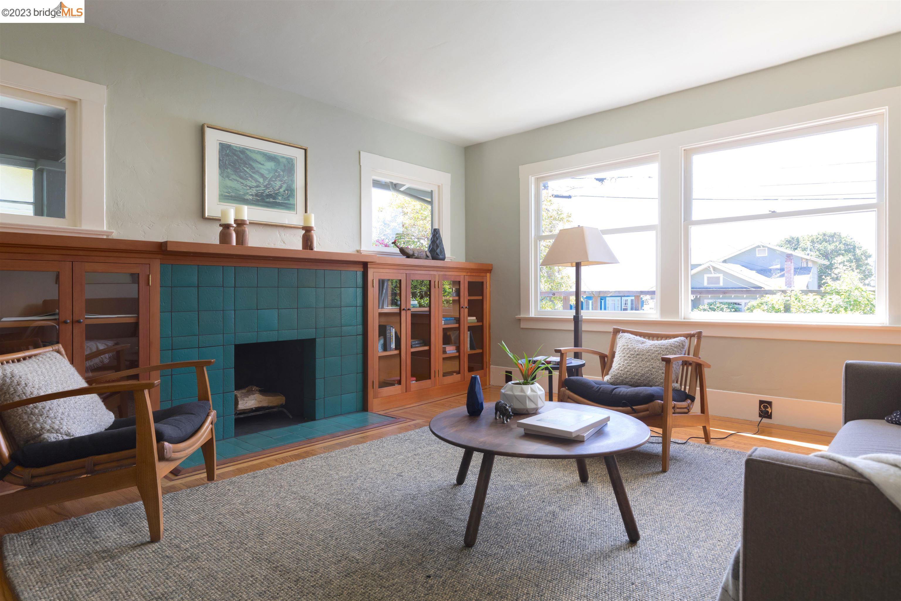 911 Tulare Avenue Berkeley, CA 94707 - Photo 3 of 21 a living room with furniture a large window and a fireplace