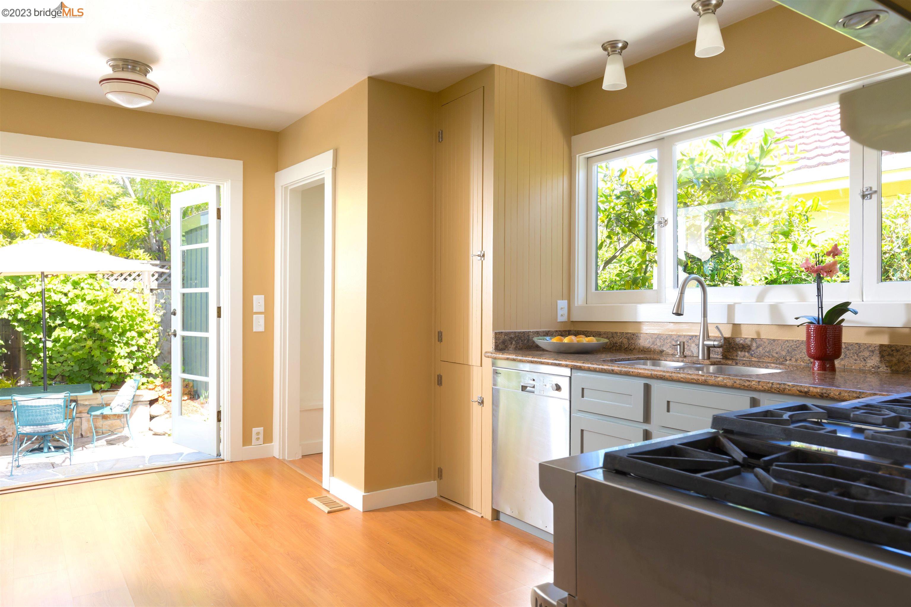 911 Tulare Avenue Berkeley, CA 94707 - Photo 10 of 21 a kitchen with granite countertop a stove and a sink