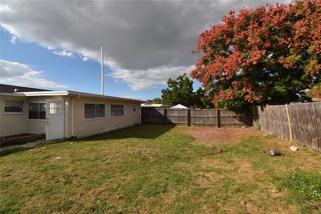 a backyard of a house with table and chairs