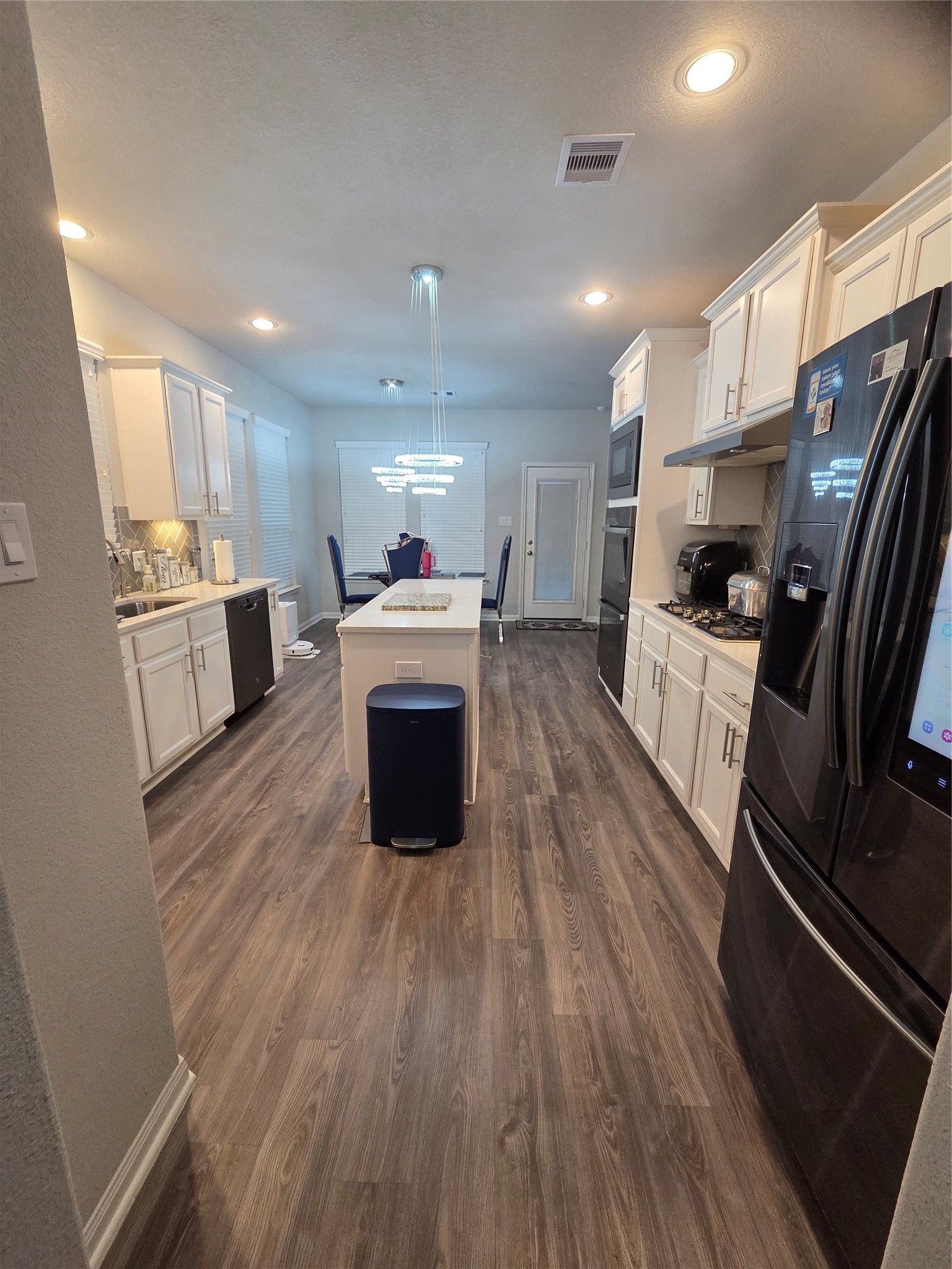 2375 Diamond D Lane Beaumont, TX 77713 - Photo 14 of 43 a large kitchen with a stove a sink dishwasher a refrigerator and wooden floor