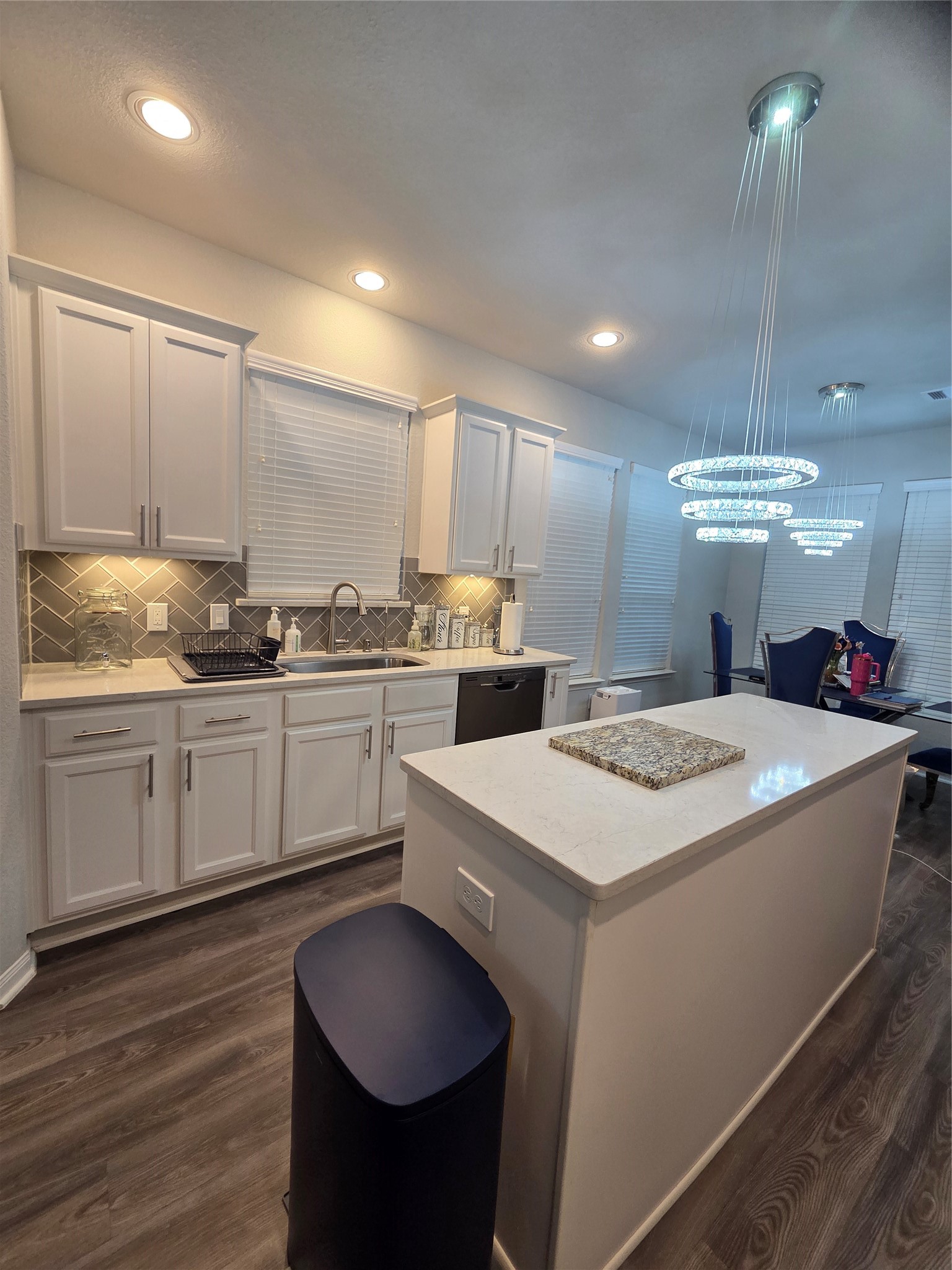 2375 Diamond D Lane Beaumont, TX 77713 - Photo 17 of 43 a kitchen with stove a sink and white cabinets with wooden floor