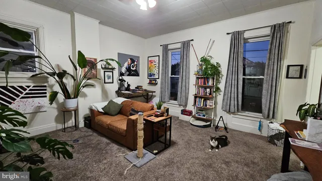 a living room with furniture and floor to ceiling window