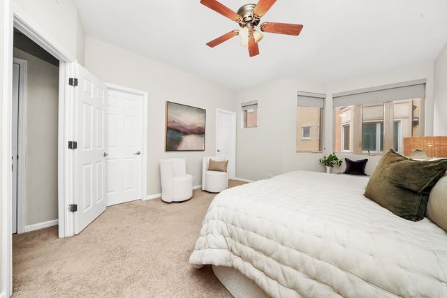 a bed room with a bed and a chandelier