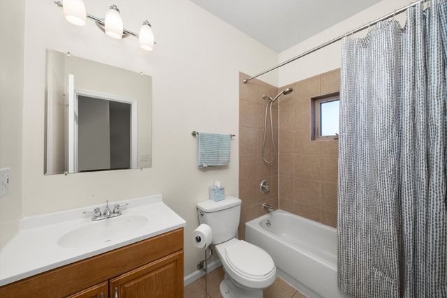 a bathroom with a sink a toilet a mirror and shower