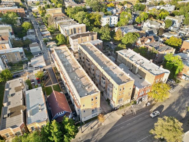 an aerial view of a house with a yard garage and lake view in back