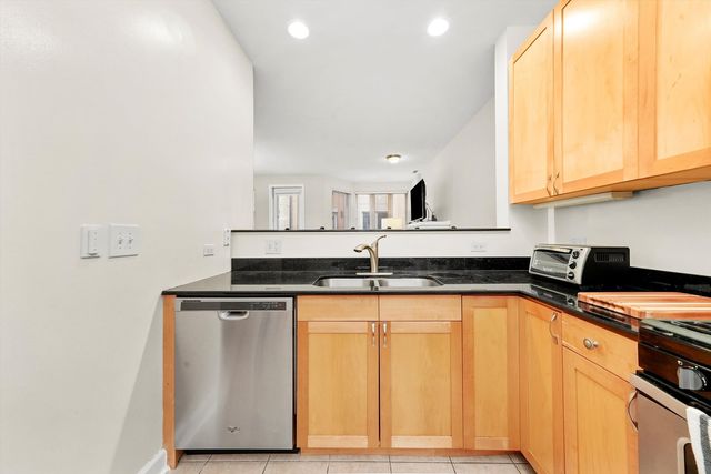 a kitchen with granite countertop a sink and a stove