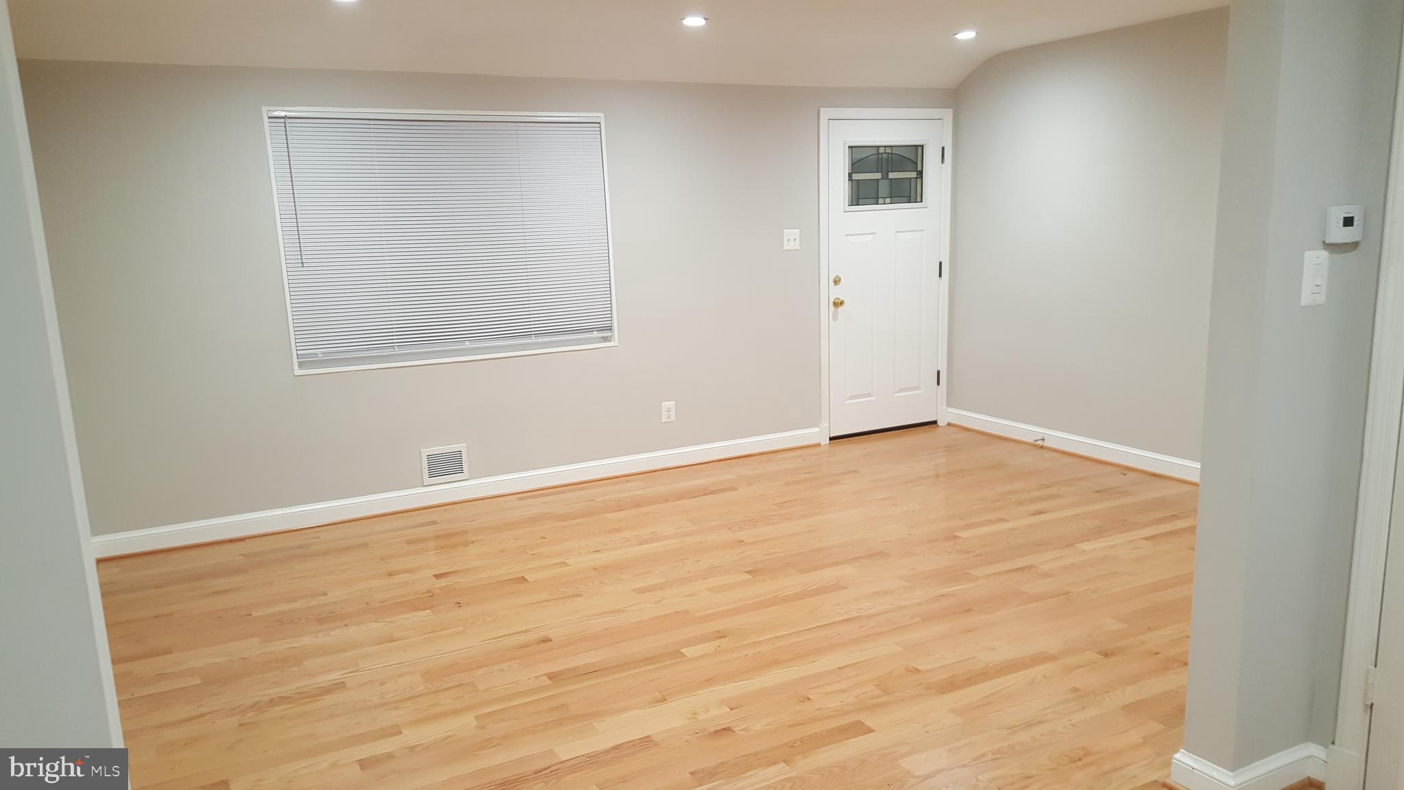 11102 Bucknell Drive Silver Spring, MD 20902 - Photo 9 of 14 an empty room with wooden floor and windows