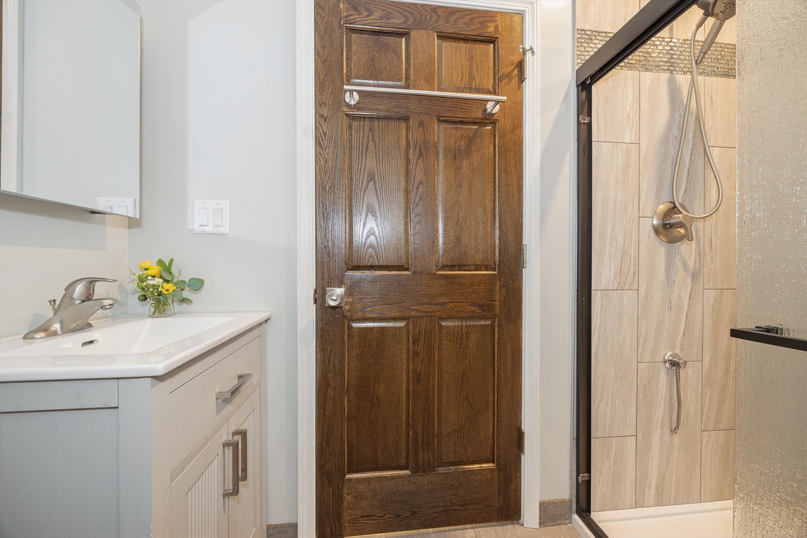 2008 West Addison Street, Unit 2 Chicago, IL 60618 - Photo 18 of 19 a bathroom with a sink a mirror and shower