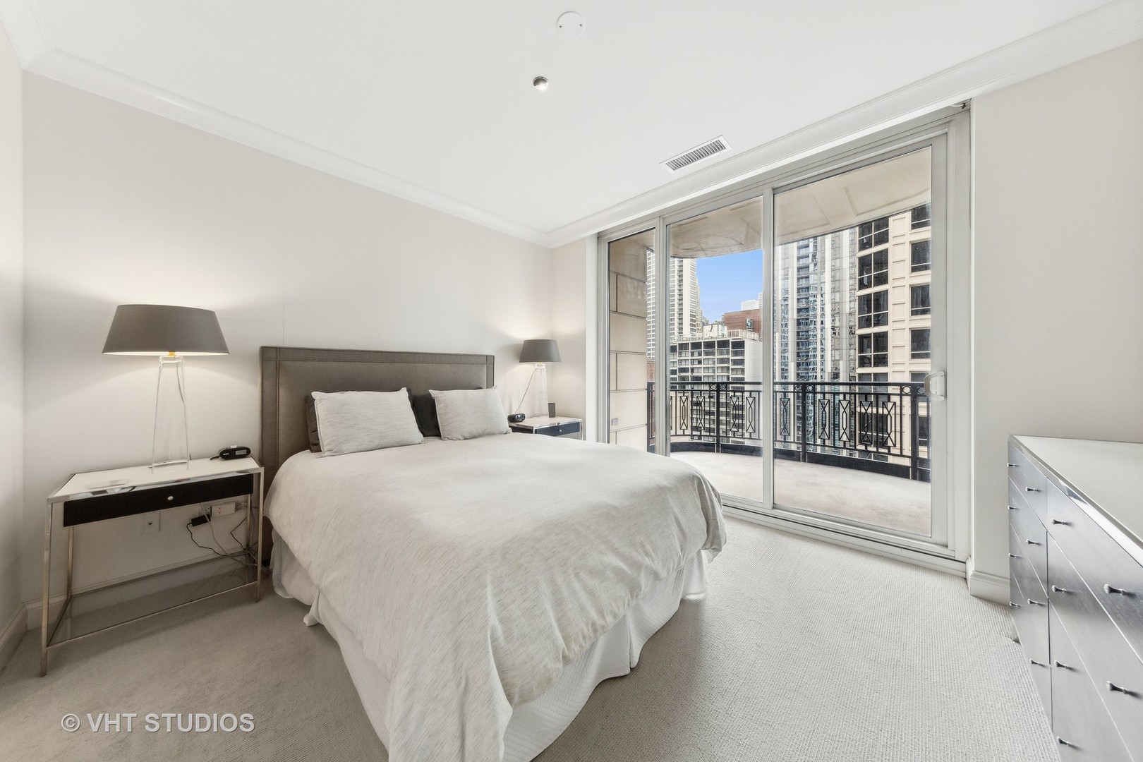 10 East Delaware Place, Unit 19C Chicago, IL 60611 - Photo 12 of 25 a bedroom with a large bed and a large window