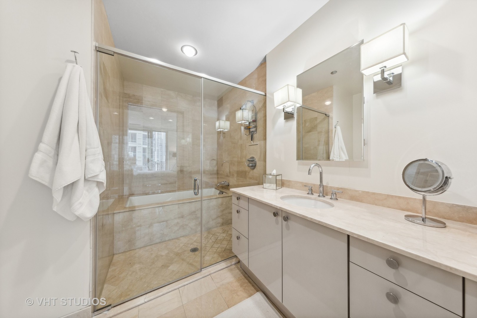10 East Delaware Place, Unit 19C Chicago, IL 60611 - Photo 13 of 25 a bathroom with a double vanity sink mirror and shower