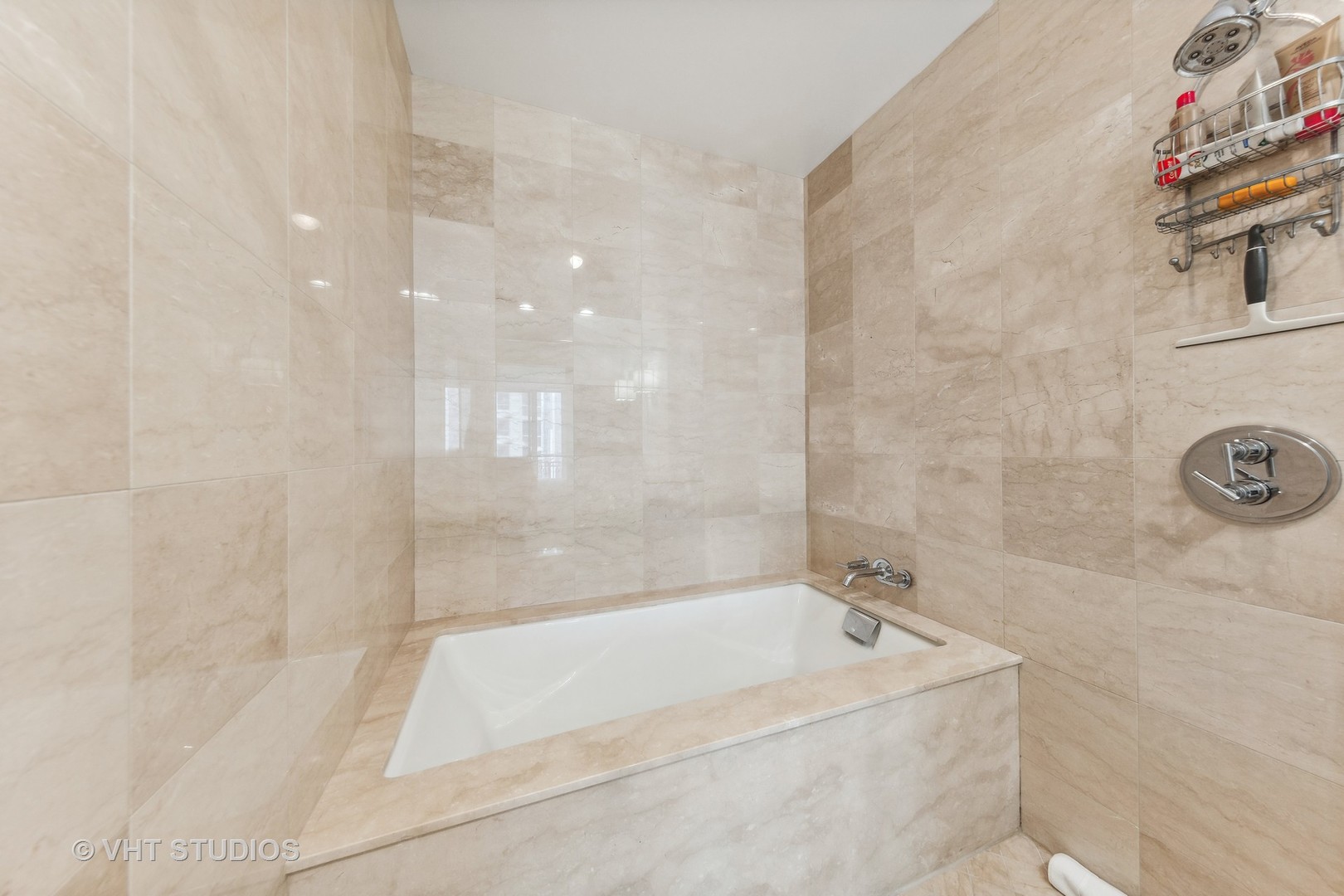 10 East Delaware Place, Unit 19C Chicago, IL 60611 - Photo 14 of 25 a bathroom with a bathtub and shower