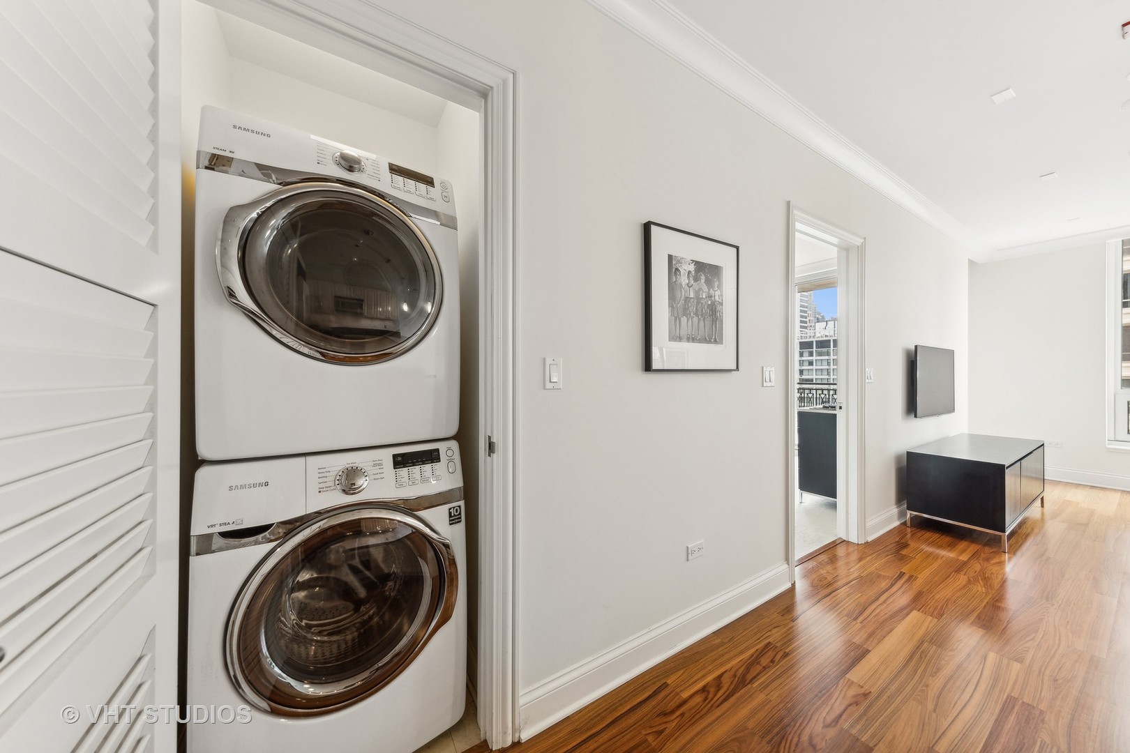 10 East Delaware Place, Unit 19C Chicago, IL 60611 - Photo 17 of 25 a view of a hallway with washer and dryer