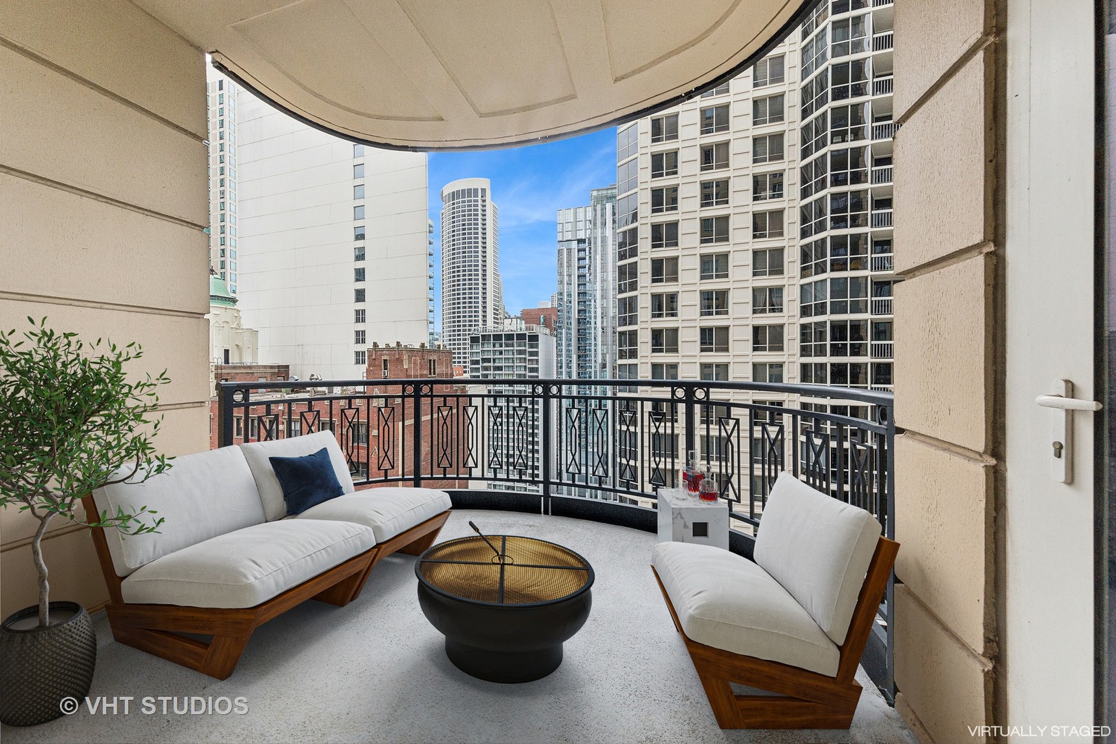 10 East Delaware Place, Unit 19C Chicago, IL 60611 - Photo 18 of 25 a balcony with furniture and a potted plant