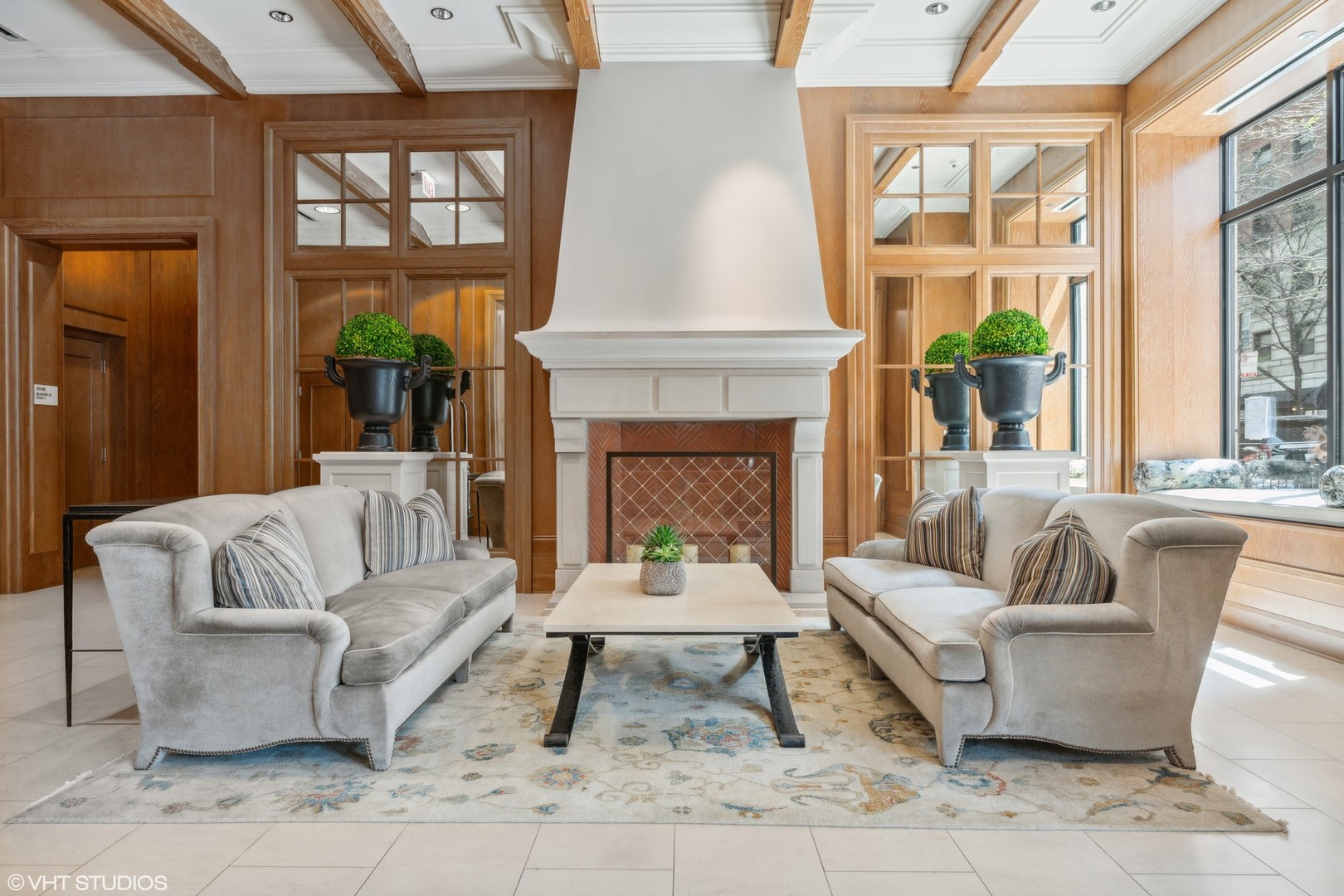 10 East Delaware Place, Unit 19C Chicago, IL 60611 - Photo 3 of 25 a living room with furniture a rug and a fireplace