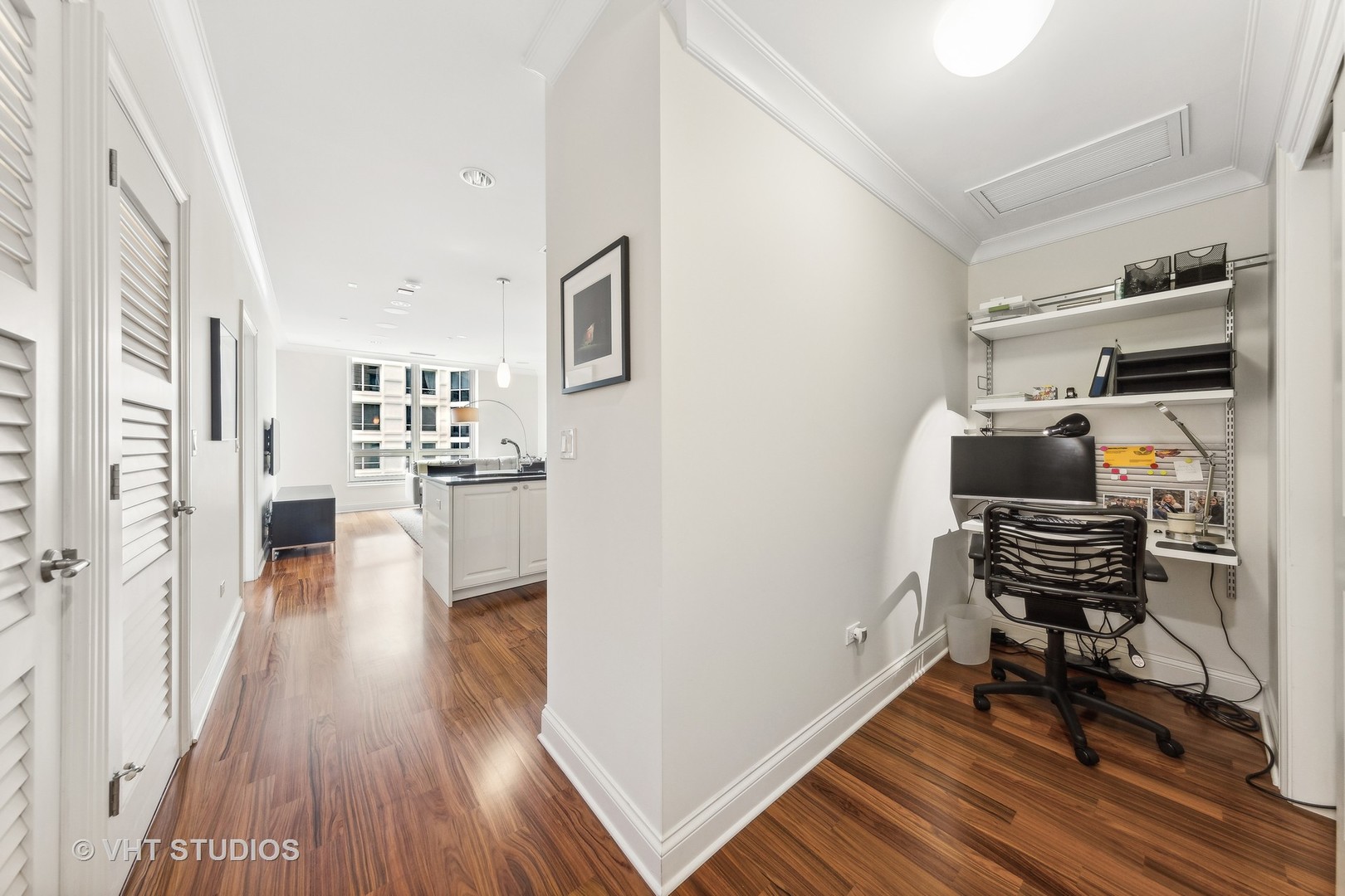 10 East Delaware Place, Unit 19C Chicago, IL 60611 - Photo 4 of 25 a view of a workspace with furniture and wooden floor