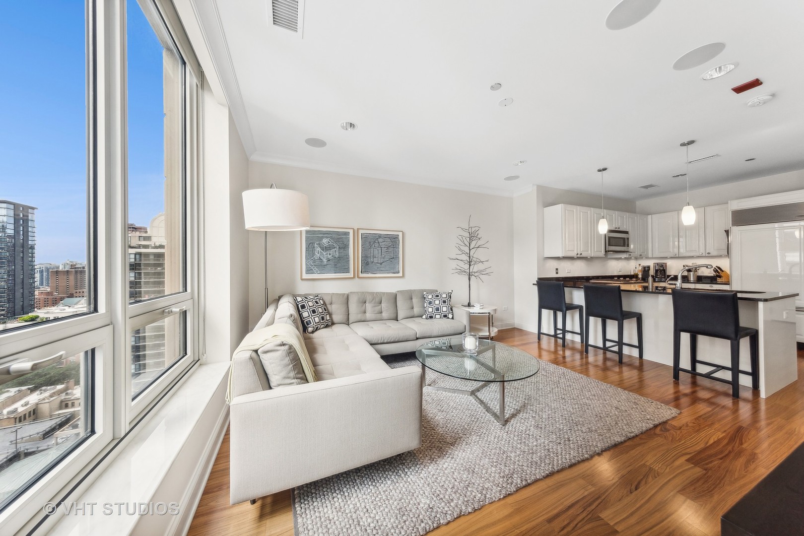 10 East Delaware Place, Unit 19C Chicago, IL 60611 - Photo 8 of 25 a living room with furniture and a large window