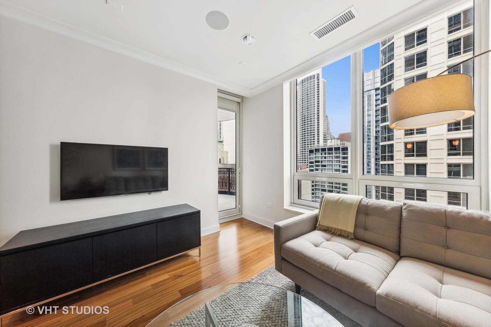 10 East Delaware Place, Unit 19C Chicago, IL 60611 - Photo 9 of 25 a living room with furniture and a flat screen tv