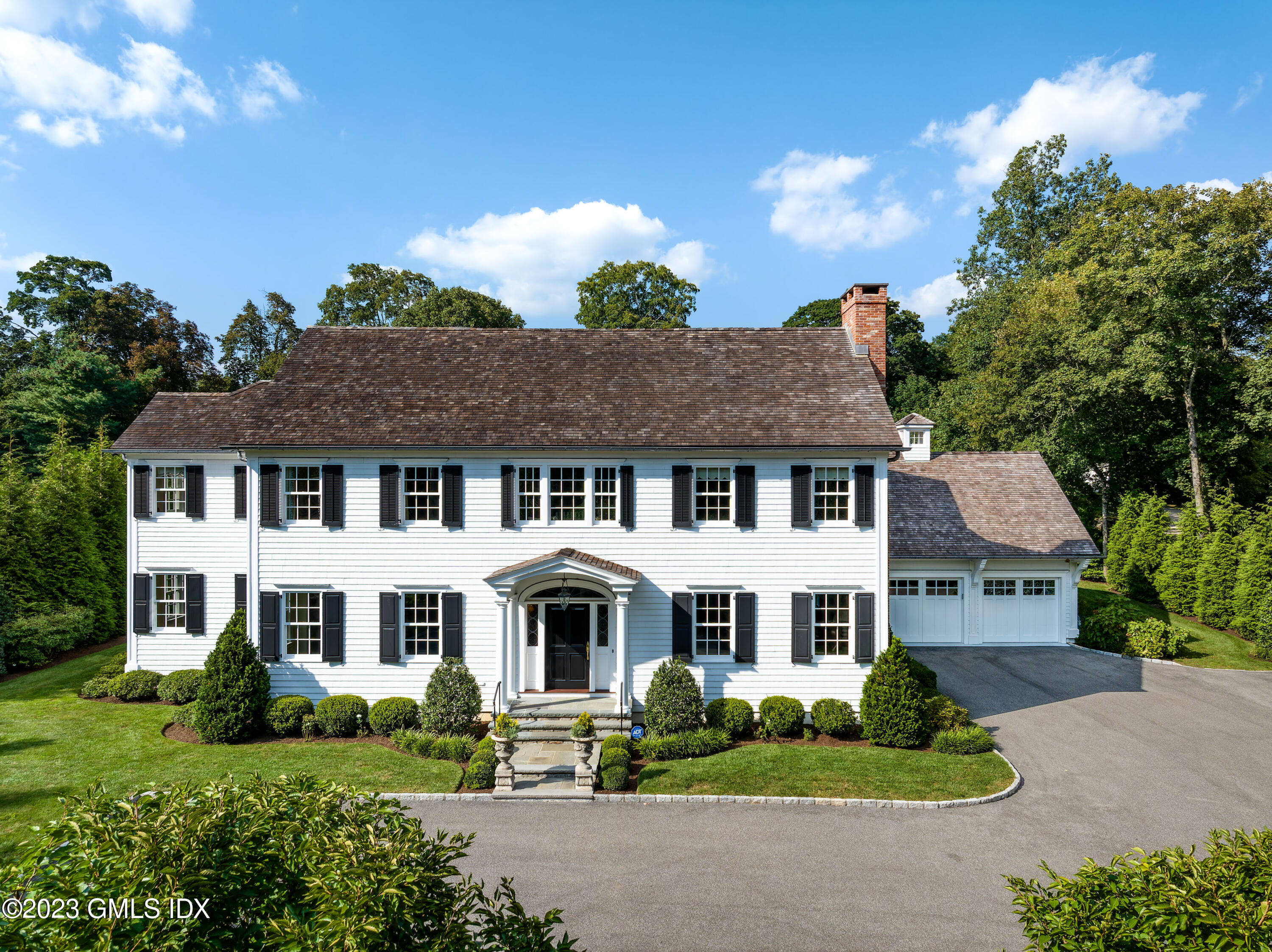 a aerial view of a house with a yard and potted plants