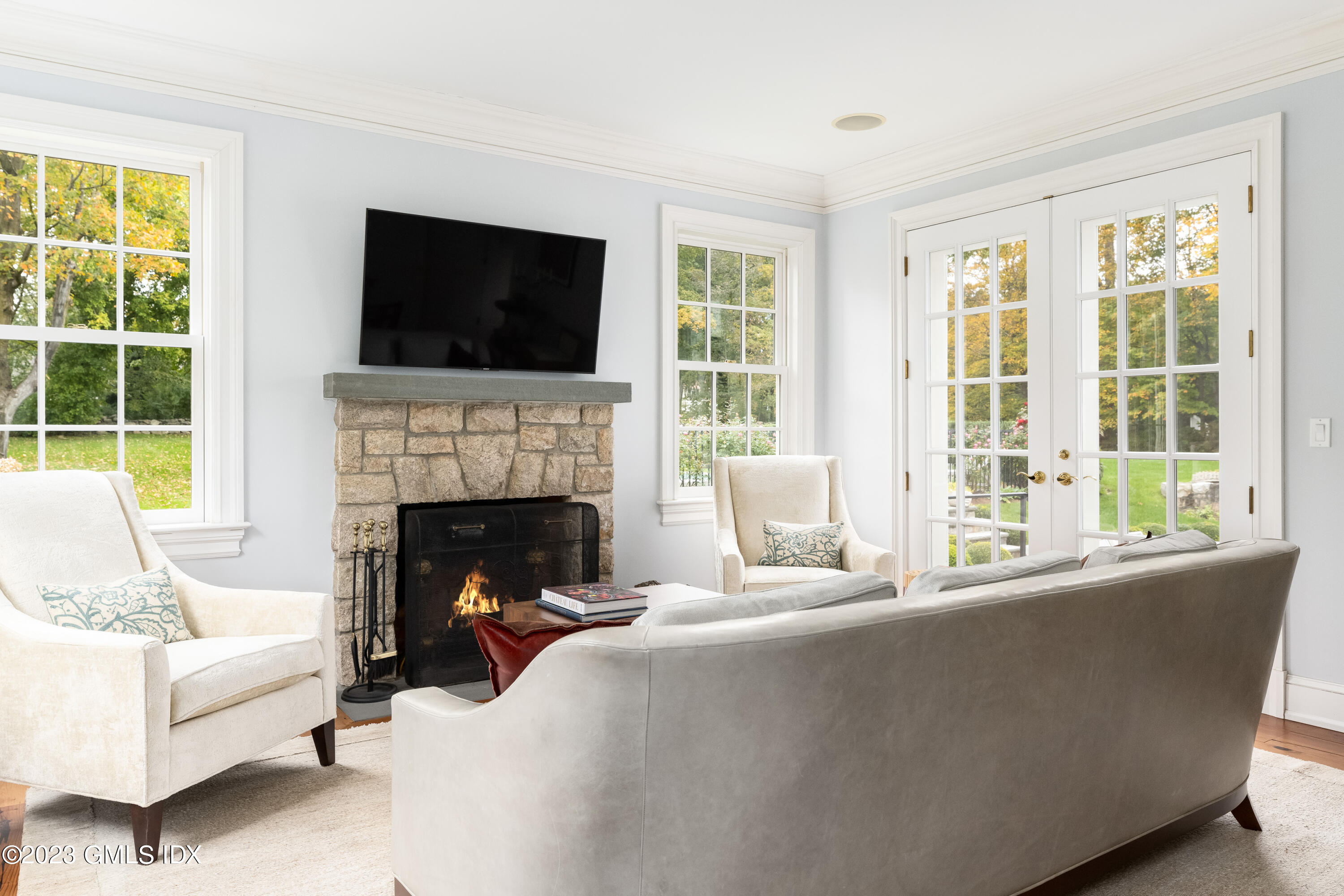 6 Hill Road Greenwich, CT 06830 - Photo 12 of 35 a living room with furniture fireplace and a flat screen tv