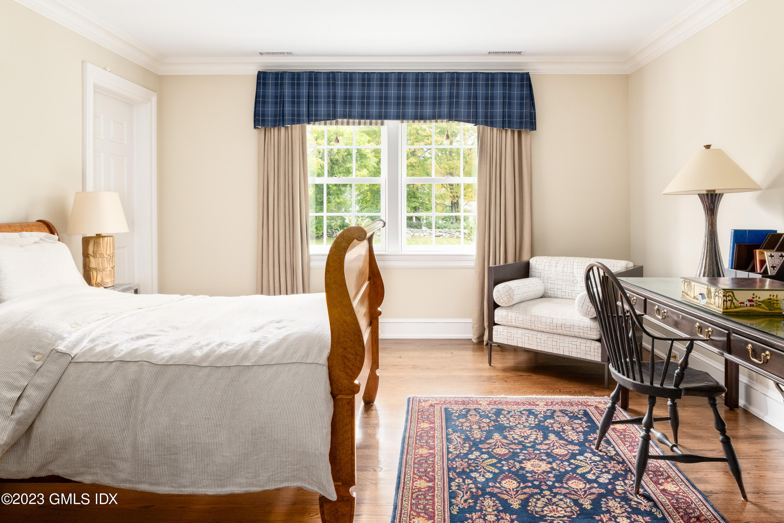 6 Hill Road Greenwich, CT 06830 - Photo 19 of 35 a bedroom with a bed a lamp and a large window