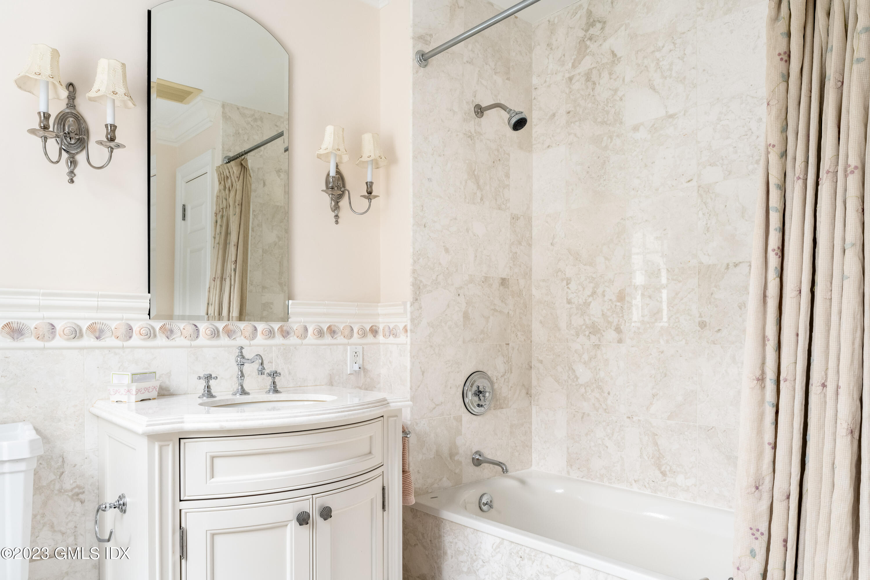 6 Hill Road Greenwich, CT 06830 - Photo 23 of 35 a bathroom with a sink a mirror a bathtub and shower
