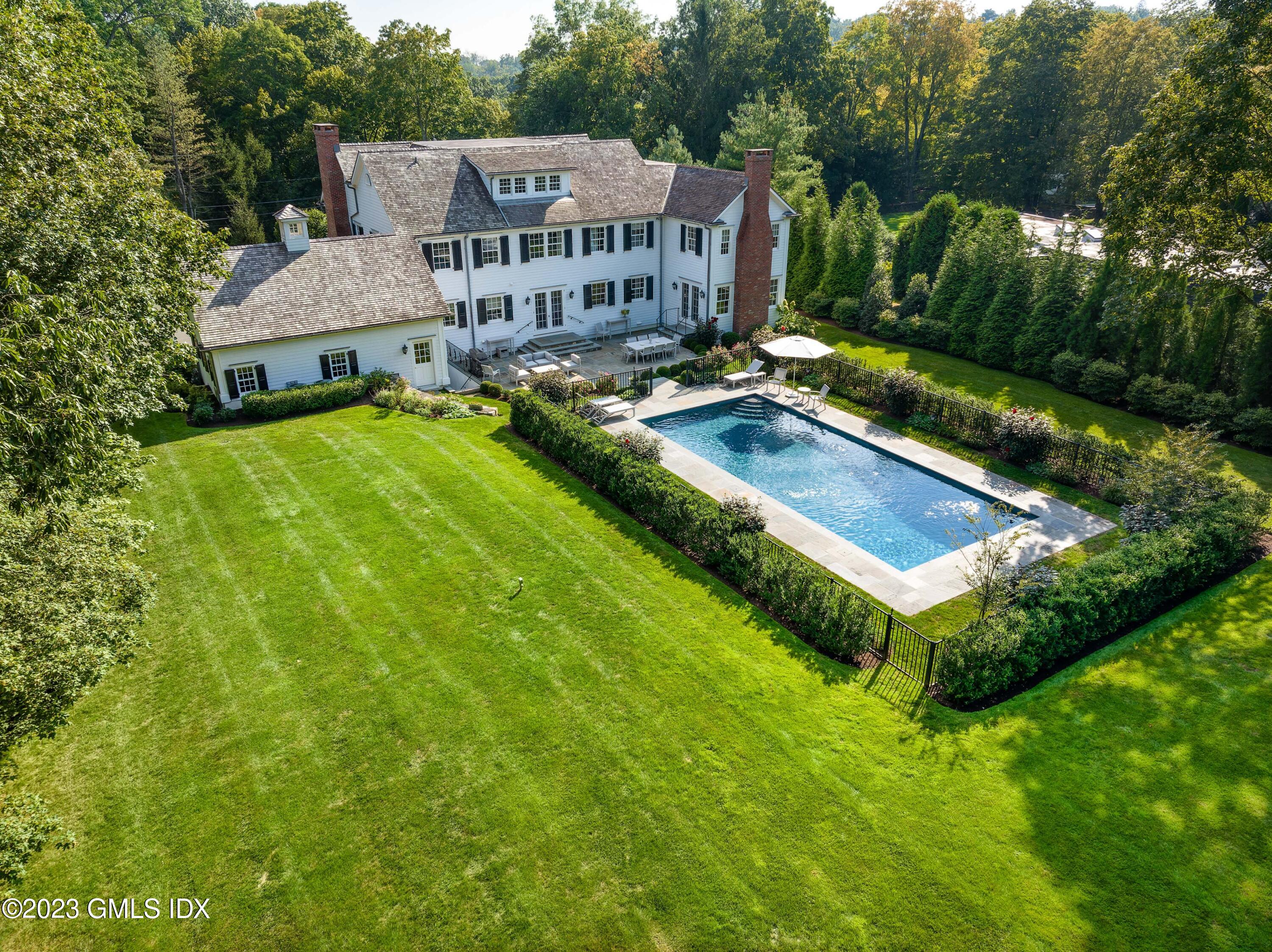 6 Hill Road Greenwich, CT 06830 - Photo 25 of 35 a view of a house with pool and sitting area