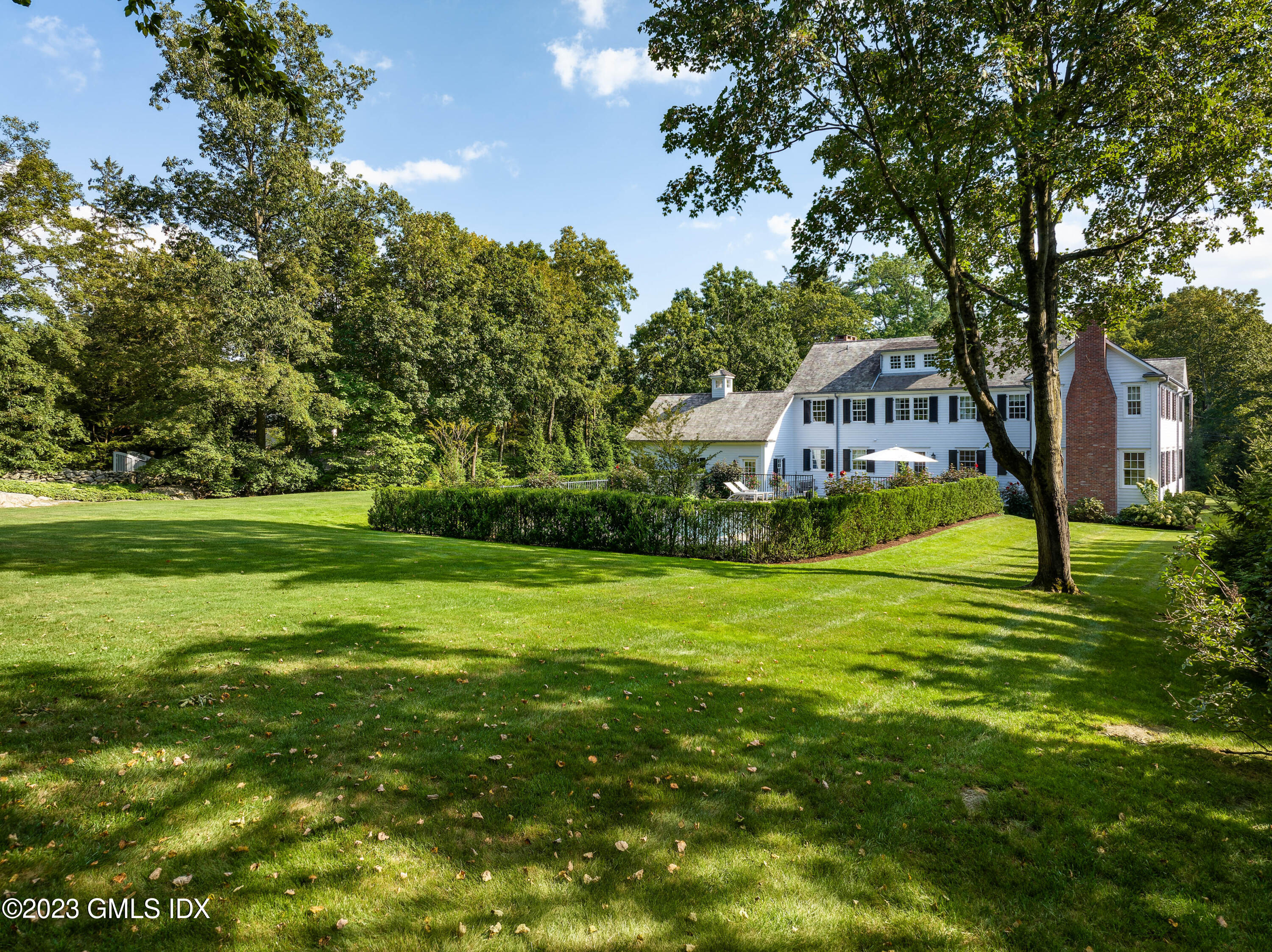 6 Hill Road Greenwich, CT 06830 - Photo 27 of 35 a view of a swimming pool with a garden