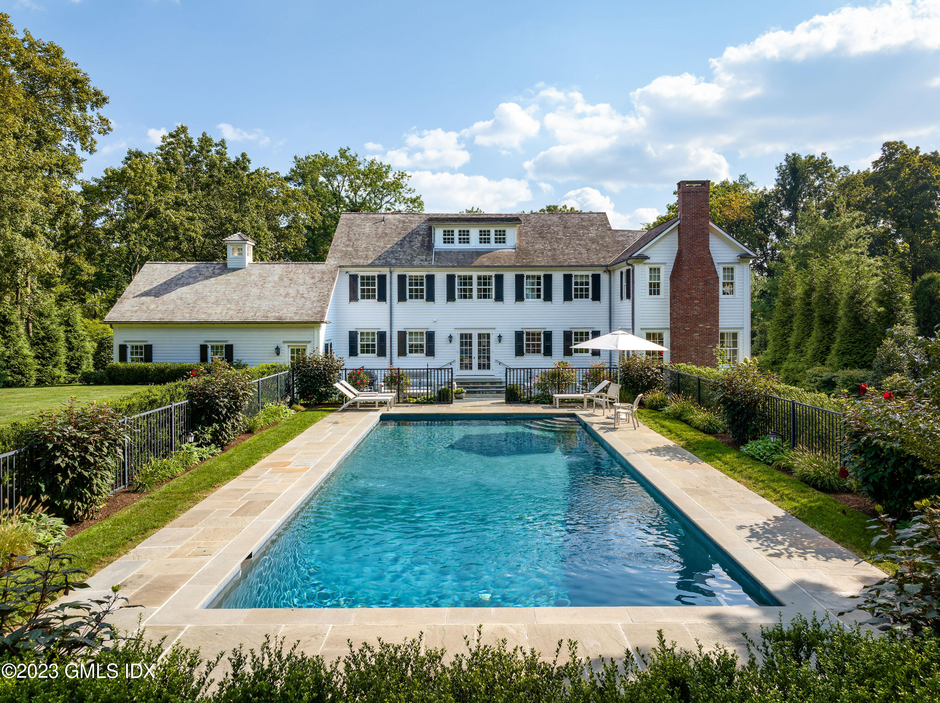 6 Hill Road Greenwich, CT 06830 - Photo 29 of 35 a view of house with garden and a swimming pool