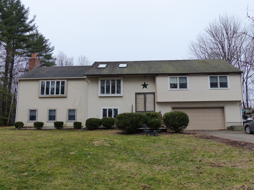 86 Highland Road Merrimac, MA 01860 - Photo 2 of 12 a front view of a house with a garden