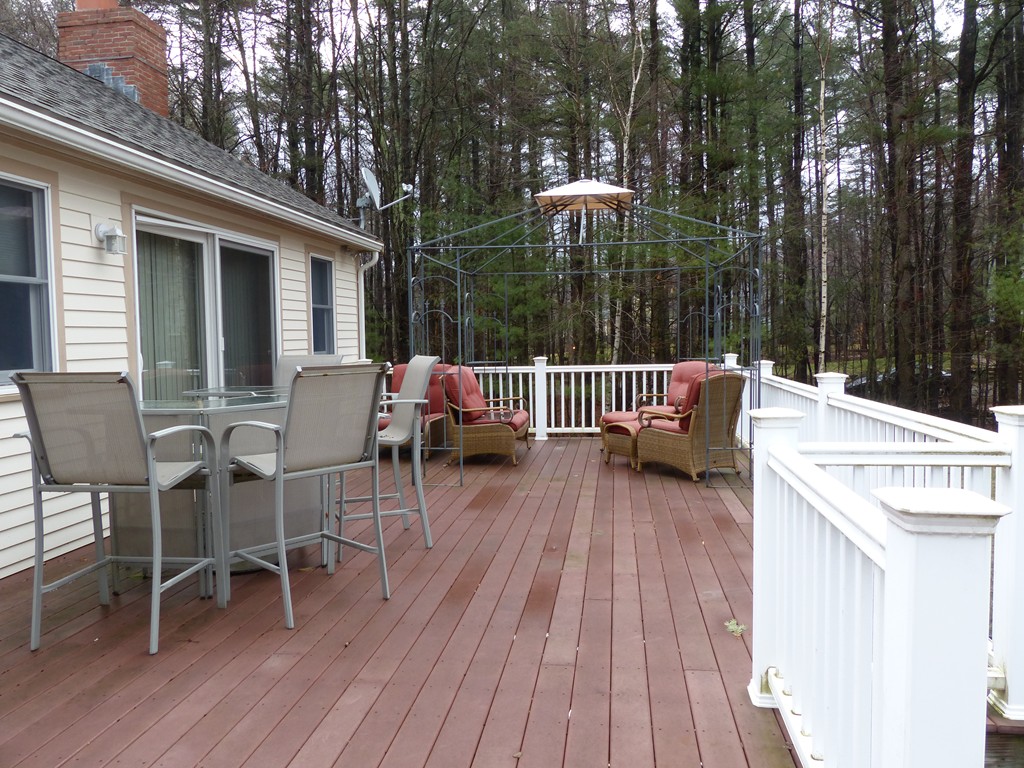 86 Highland Road Merrimac, MA 01860 - Photo 3 of 12 a wooden bench sitting in front of a house